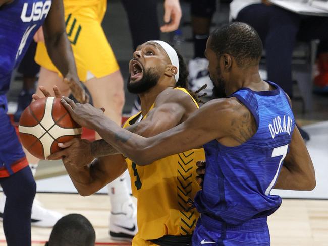 LAS VEGAS, NEVADA - JULY 12:  Patty Mills #5 of the Australia Boomers is fouled by Kevin Durant #7 of the United States during an exhibition game at Michelob Ultra Arena ahead of the Tokyo Olympic Games on July 12, 2021 in Las Vegas, Nevada.  (Photo by Ethan Miller/Getty Images)