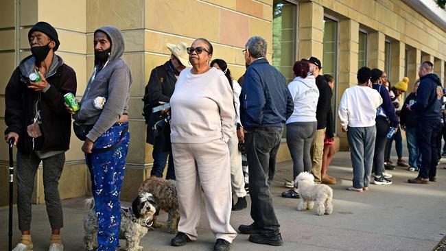 People arrive with their pets at an evacuation centre in the Pasadena Convention Center in Pasadena, California, as they flee wildfires. Picture: AFP