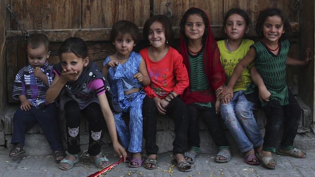 A group of Afghan children sit outside their house in Kabul, Afghanistan on August 3. Picture: AP