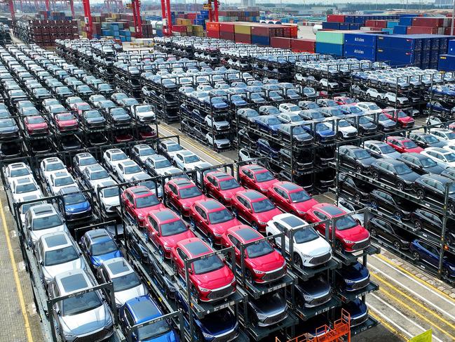 (FILES) This photo taken on September 11, 2023, shows BYD electric cars awaiting to be loaded onto a ship at the international container terminal of Taicang Port at Suzhou Port, in Chinaâs eastern Jiangsu Province. Struggling foreign automakers in China are looking for help from local tech giants to try and stay competitive in the world's biggest electric car market, where shiny smart screens, assisted driving and sophisticated map technology are in high demand. (Photo by AFP) / China OUT / To go with China-economy-auto-technology-EVs, FOCUS by Peter Catterall and Qasim Nauman