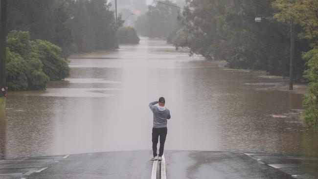 A man stands on Windsor Road in McGraths Hill, western Sydney, on Tuesday. Picture: Getty Images