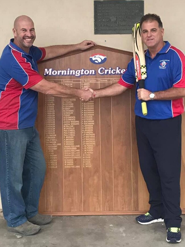 Darren Berry (right) and Mornington Cricket Club president Lee Garnet shake on it.