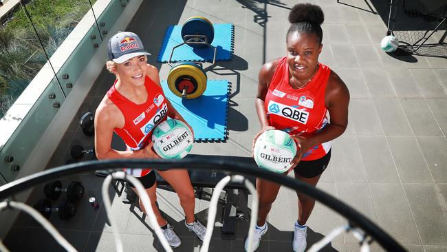 NSW Swifts players Helen Housby, left, and Sam Wallace, have set up a makeshift training facility on the balcony of the flat they share in Sydney. Picture: John Feder