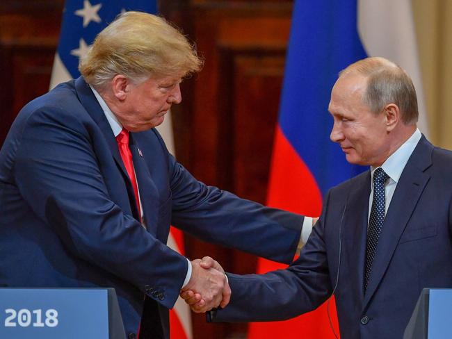 Donald Trump (L) and Vladimir Putin shake hands before attending a joint press conference after a meeting at the Presidential Palace in Helsinki, on July 16, 2018. Picture: AFP