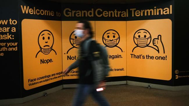 A display at Grand Central Terminal in New York shows travellers how to wear a face mask. Picture: Getty Images