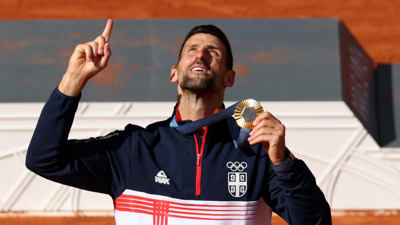 Gold medallist Novak Djokovic celebrates.