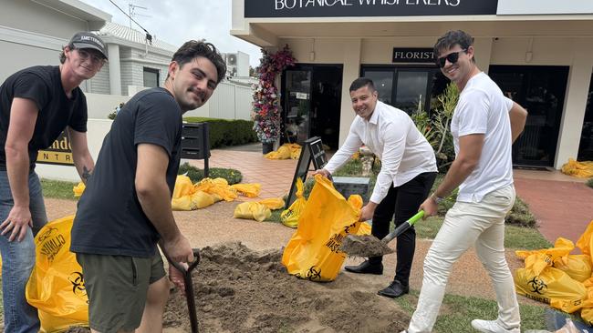 Taj Pearce, Ethan Thomas, Jason Widdows and Franklin Calugay help prepare sandbags to protect businesses at Paradise Point ahead of Cyclone Alfred on Wednesday March 5, 2023. Photo: Kathleen Skene