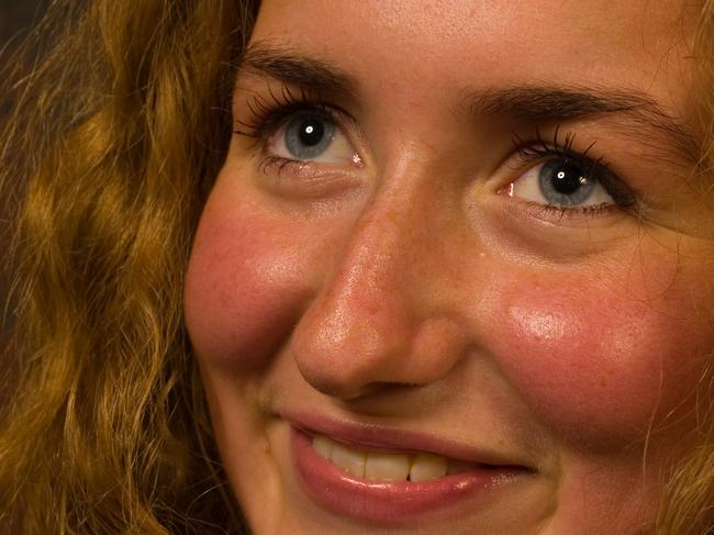 Smiling young blonde girl with red cheeks