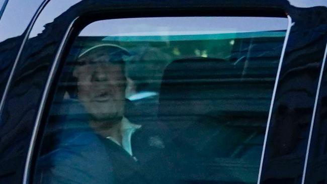 Donald Trump watches the crowds from his Presidential state car as he returns to the White House after playing golf. Picture: AFP.