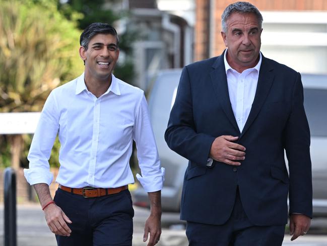 Britain's Prime Minister Rishi Sunak (L) arrives with newly elected MP Steve Tuckwell to a cafe in Ruislip on July 21, 2023 after a by-election in the northwest London constituency of Uxbridge and South Ruislip. Britain's ruling Conservatives held the former seat of ex-Prime Minister Boris Johnson but saw hefty majorities in two other seats blown away as scandals and high inflation took their toll. (Photo by JUSTIN TALLIS / AFP)