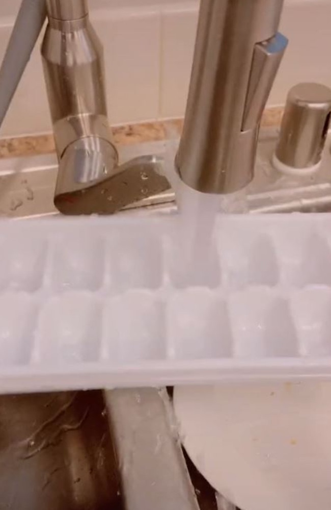 Turns out you don’t need to spray water everywhere to fill up your ice cube tray, WHO KNEW. Picture: TikTok