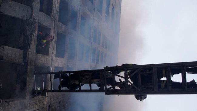 Rescuers work to get people out of a residential building that was struck, as Russia's attack on Ukraine continues, in Kyiv, Ukraine. Picture: Reuters