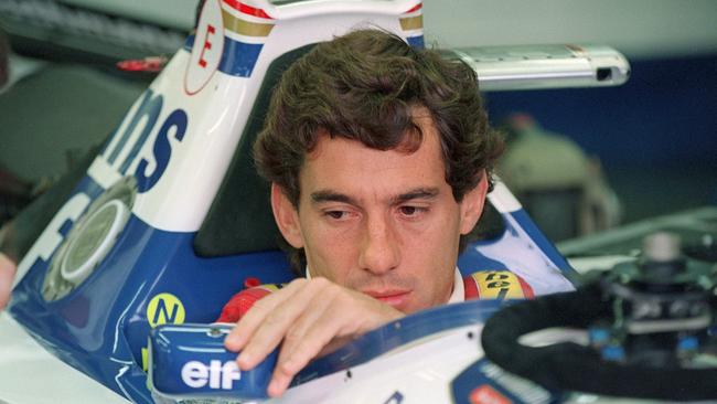 Ayrton Senna adjusts his rear view mirror in the pits before the start of the San Marino Grand Prix in Imola. Picture: AFP