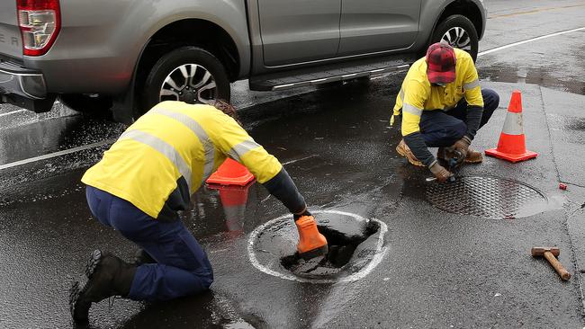 Workers at the sinkhole on Myers St. Picture: Alison Wynd