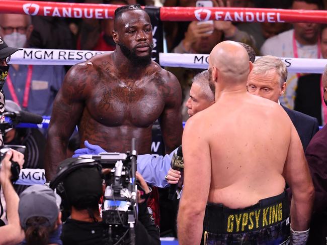 US challenger Deontay Wilder (L) faces off WBC heavyweight champion Tyson Fury of Great Britain (R) before the first round in their WBC/Lineal Heavyweight title fight, October 9, 2021 at the T-Mobile Arena in Las Vegas, Nevada. - Fury retained his WBC heavyweight crown with a spectacular 11th-round knockout of Deontay Wilder. (Photo by Robyn Beck / AFP)