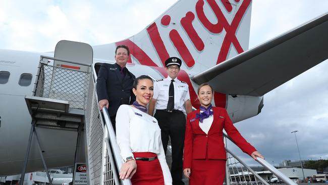 Virgin Australia crew Nico Porter, Bianca Yates, Captain Paul Anderson and Delia Taylor are set to befit from government assistance. Picture: John Feder