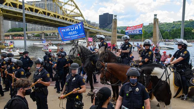 Black Lives Matter protesters and Trump supporters are kept apart by the police. Picture: Jeff Swensen/Getty Images