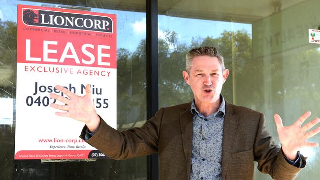 Mark Williams poses for a photograph in front of a vacant shop front. (AAP image, John Gass)