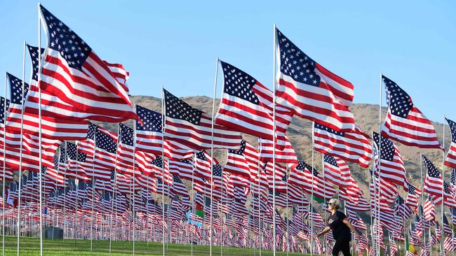 A woman walks past a display of US flags to commemorate the 20th anniversary of 9/11 with the annual Waves of Flags display and remembrance at Pepperdine University in Malibu, California on September 8. Picture: AFP