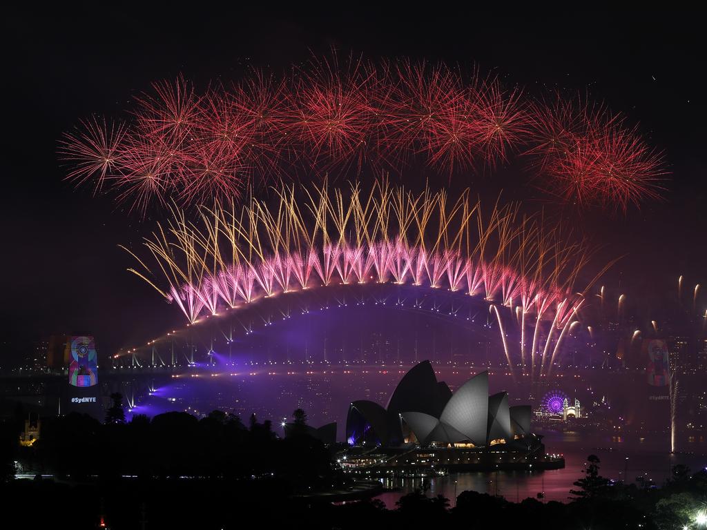 New Year's Eve 2018 - The midnight fireworks display over the Sydney Opera House and Sydney Harbour Bridge from a rooftop in Potts Point. Picture: Toby Zerna