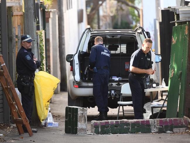 Federal and state police officers working at the crime scene in Surry Hills. Picture: AAP/Sam Mooy