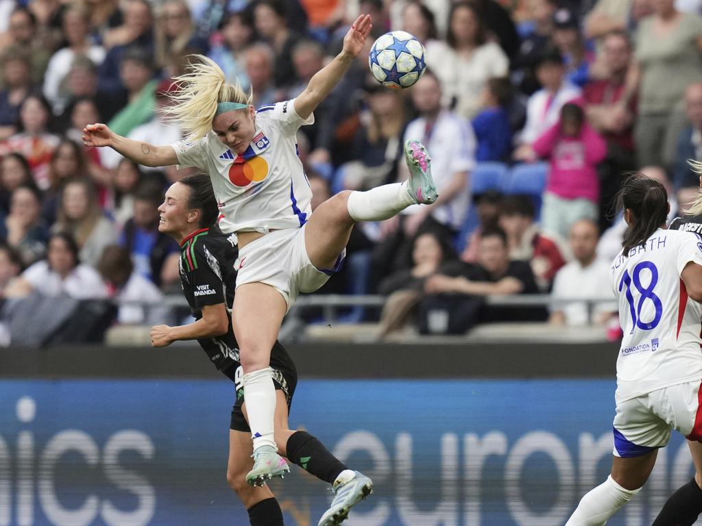 Lyon's Ellie Carpenter takes a heavy fall in a clash with Caitlin Foord. Picture: AP