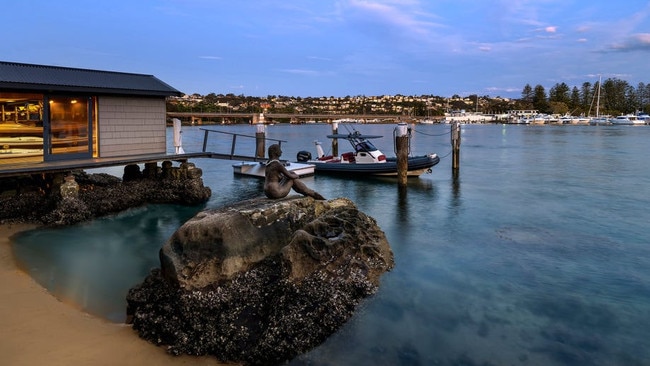 A mermaid statue, jetty, boat shed and private beach.