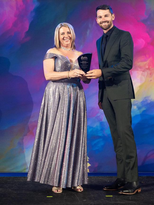 Tyler Wolfenden of Wolf Constructions accepting the award for Stoneybrook at the Master Builders Queensland Awards.