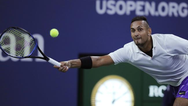 Nick Kyrgios stretches for a shot from Steve Johnson. Picture: AP