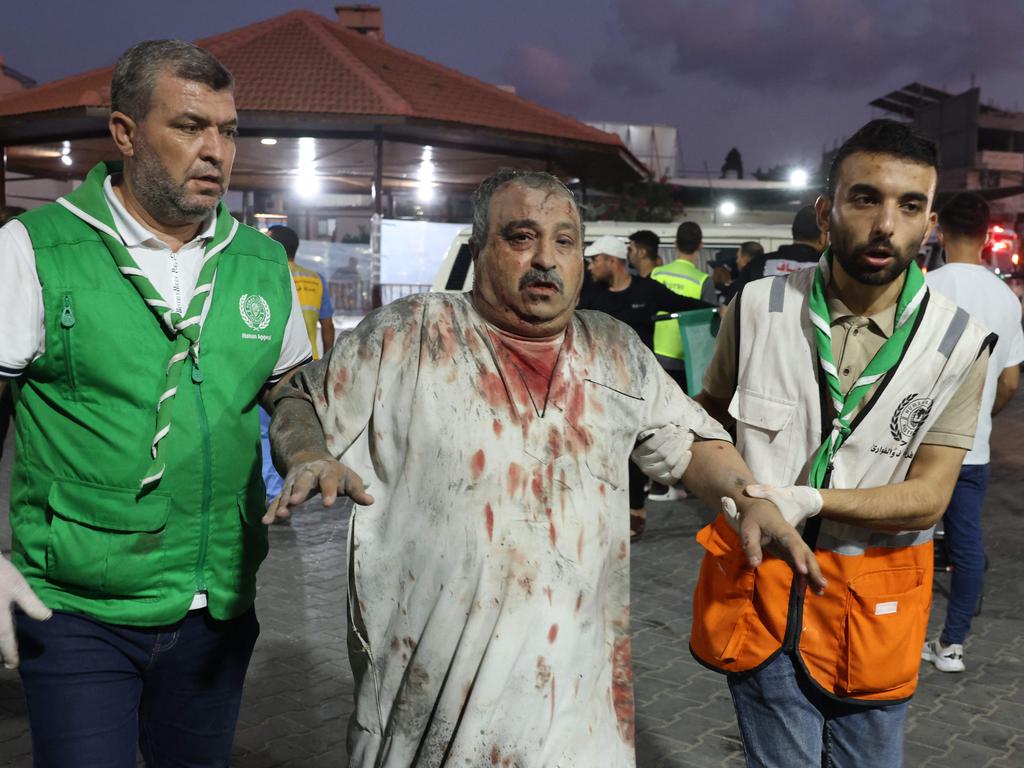 Emergency personnel help an injured Palestinian man into Al-Shifa hospital in Gaza City following an Israeli airstrike. Picture: AFP