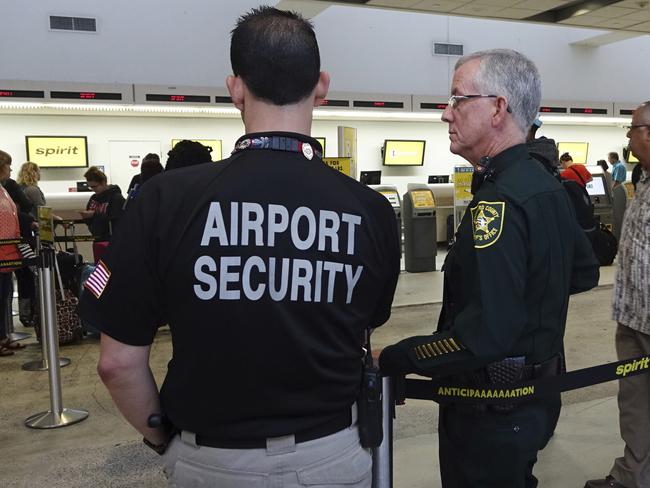 Airport Security and a Broward Sherriff's Deputy keep an eye on the line at Spirit Airlines at the Fort Lauderdale-Hollywood International Airport in Fort Lauderdale, Florida. Picture: Joe Cavaretta/South Florida Sun-Sentinel via AP