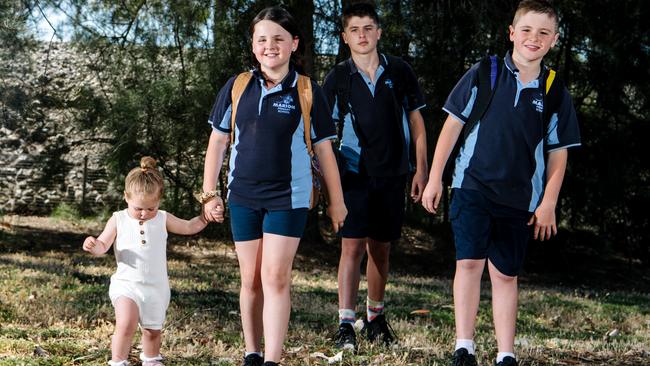 Hibberd siblings Ellie, 10, Levi, 12, and Bowen Hibberd, 10 head off to school late last year with baby sister, Frankie, 1. Twins Ellie and Bowen are in year 5 at Marion and Levi has just started at Seaview High School, in year 7. Picture: Morgan Sette