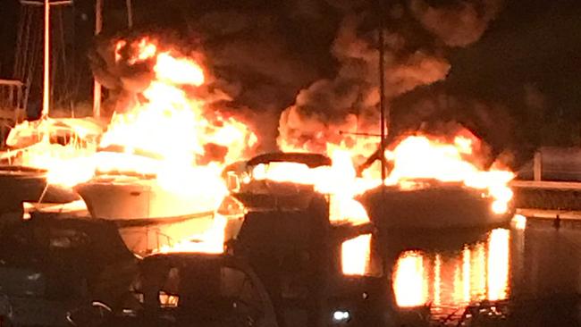 Boats on fire at Hope Harbour Marina in Hope Island after the arson. Picture: Anna Wood.