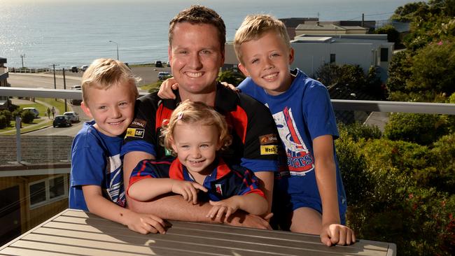 Recovering from a brain tumour ... former Knights player Mark Hughes at home with his children Dave, 5, Bonnie, 2, and Zac 9.