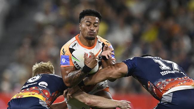 TOWNSVILLE, AUSTRALIA - MAY 24: Fonua Pole of the Tigers is tackled during the round 12 NRL match between North Queensland Cowboys and Wests Tigers at Qld Country Bank Stadium, on May 24, 2024, in Townsville, Australia. (Photo by Ian Hitchcock/Getty Images)