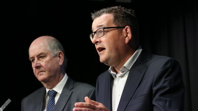 Victorian Premier Daniel Andrews (right) speaks to the media yesterday.