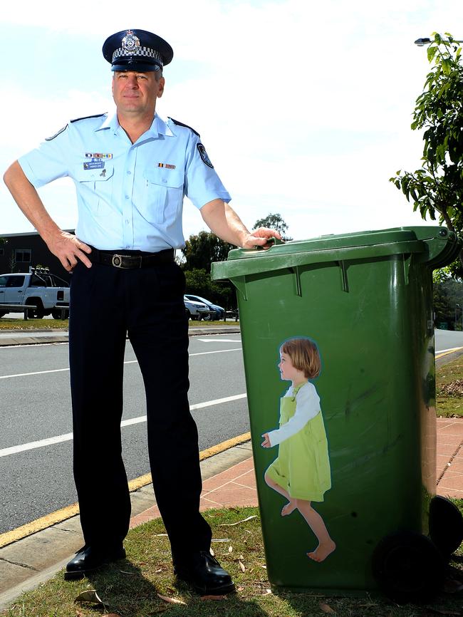 Sen Sgt Andrew Lake with one of the stickers on a wheelie bin. Picture: John Gass