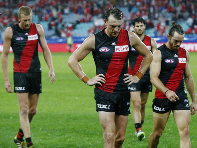 Dejected Bombers troop off led by Brendan Goddard. Picture: Wayne Ludbey