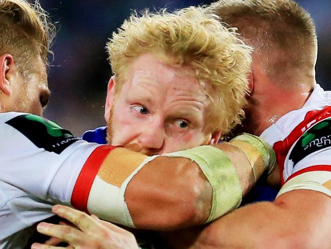 James Graham of the Bulldogs tackled  during the Canterbury Bulldogs v St George Illawarra Dragons round 21 NRL game at ANZ Stadium, Sydney Olympic Park. pic Mark Evans