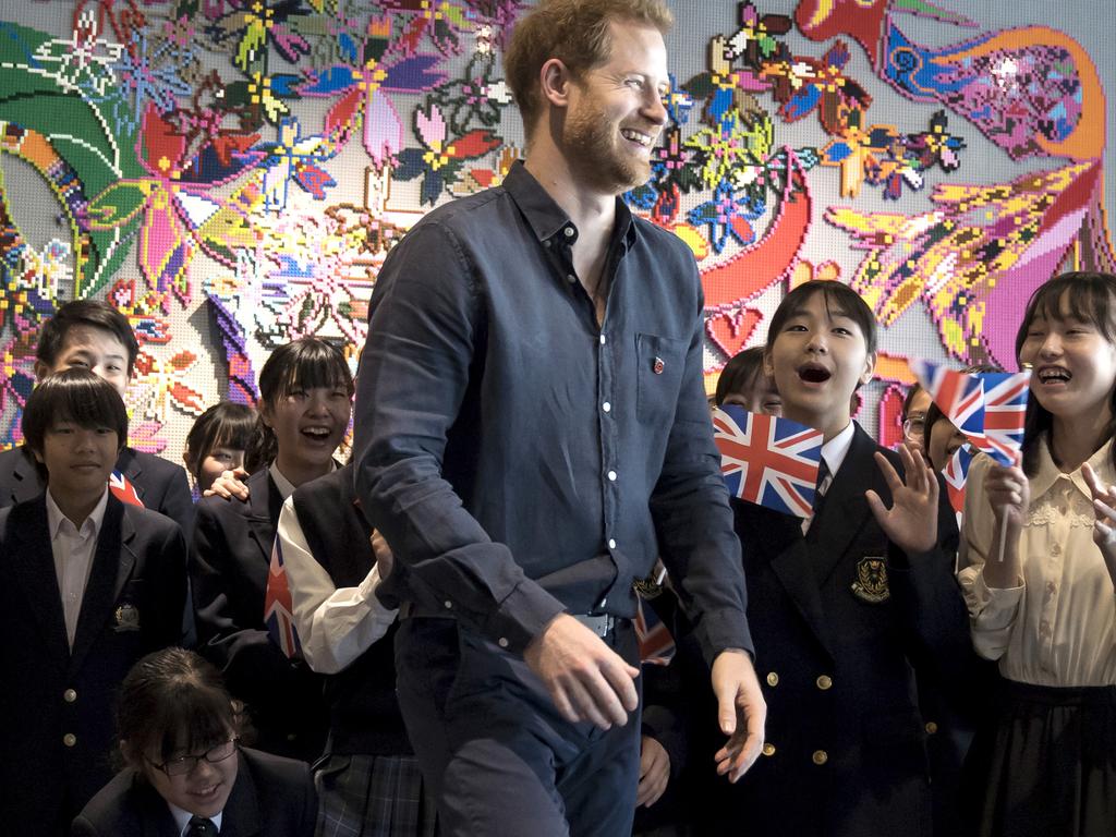 Britain's Prince Harry leaves a photo session with students as he visits the Nippon Foundation Para Arena in Tokyo. Picture: AP