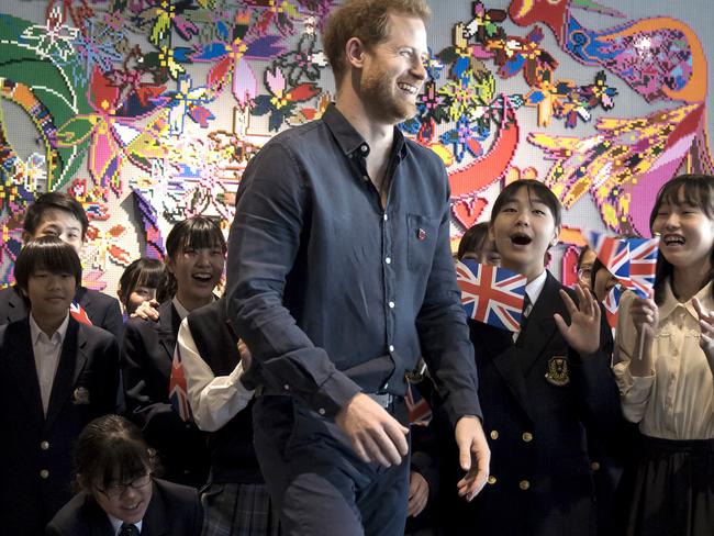 Britain's Prince Harry leaves a photo session with students as he visits the Nippon Foundation Para Arena in Tokyo. Picture: AP