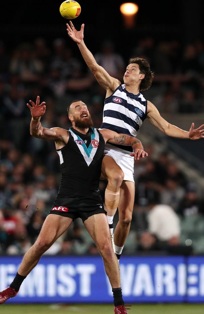 Shannon Neale leaps over Charlie Dixon last year. Picture: Sarah Reed/AFL Photos via Getty Images