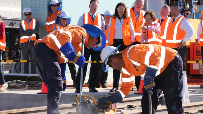 Premier Annastacia Palaszczuk joined by Deputy Premier and Minister for Transport Jackie Trad, Mayor Tom Tate and Federal MP Steve Ciobo to view the final rail weld to complete track laying of the Gold Coast Light Rail Stage 2 at Helensvale Station. Picture Glenn Hampson