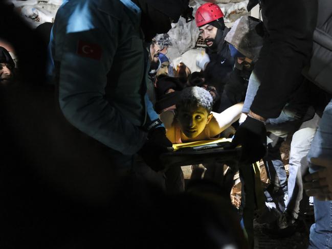 A boy is rescued by locals and volunteers in Elbistan, Turkey. Picture: Getty Images