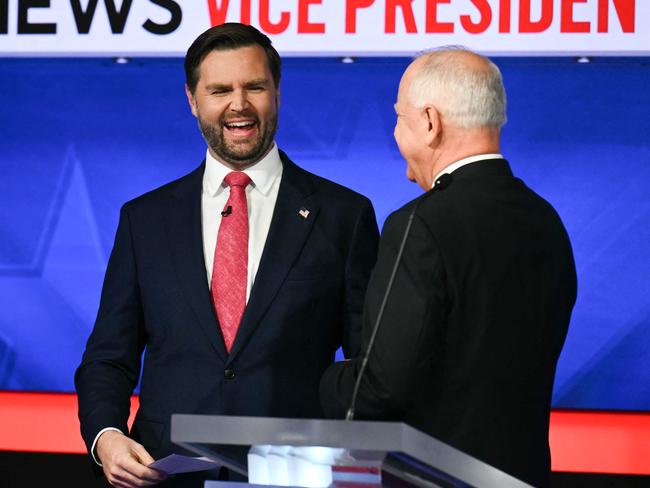 TOPSHOT - US Senator and Republican vice presidential candidate J.D. Vance (L) and Minnesota Governor and Democratic vice presidential candidate Tim Walz talk with each other at the end of the Vice Presidential debate hosted by CBS News at the CBS Broadcast Center in New York City on October 1, 2024. (Photo by ANGELA WEISS / AFP)