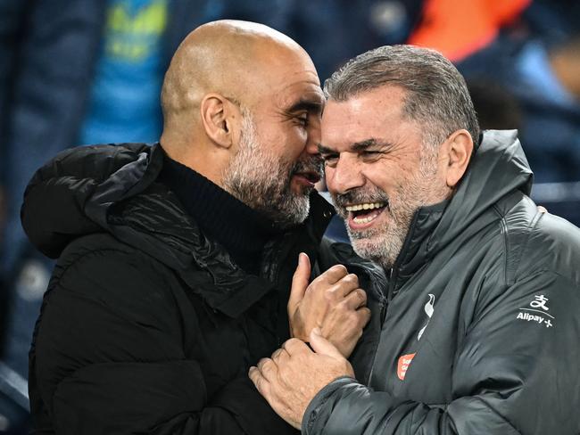 Manchester City's Spanish manager Pep Guardiola (L) and Tottenham Hotspur's Greek-Australian Head Coach Ange Postecoglou laugh together during the English Premier League football match between Manchester City and Tottenham Hotspur at the Etihad Stadium in Manchester, north west England, on November 23, 2024. (Photo by Paul ELLIS / AFP) / RESTRICTED TO EDITORIAL USE. No use with unauthorized audio, video, data, fixture lists, club/league logos or 'live' services. Online in-match use limited to 120 images. An additional 40 images may be used in extra time. No video emulation. Social media in-match use limited to 120 images. An additional 40 images may be used in extra time. No use in betting publications, games or single club/league/player publications. /