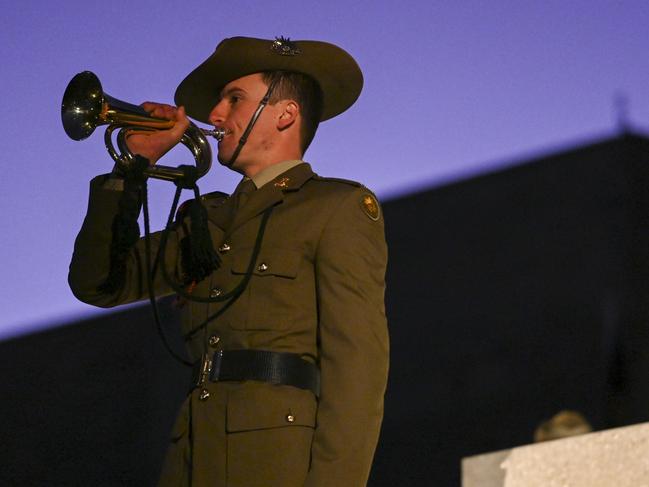 CANBERRA, AUSTRALIA - APRIL 25: Australian Defence force bugler during the Dawn Service at the Australian War Memorial on April 25, 2023 in Canberra, Australia. Anzac Day is a national holiday in Australia, traditionally marked by a dawn service held during the time of the original Gallipoli landing and commemorated with ceremonies and parades throughout the day. Anzac Day commemorates the day the Australian and New Zealand Army Corp (ANZAC) landed on the shores of Gallipoli on April 25, 1915, during World War 1. (Photo by Martin Ollman/Getty Images)