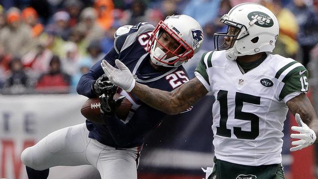 New England Patriots defensive back Eric Rowe (25) intercepts a pass intended for New York Jets wide receiver Brandon Marshall (15)