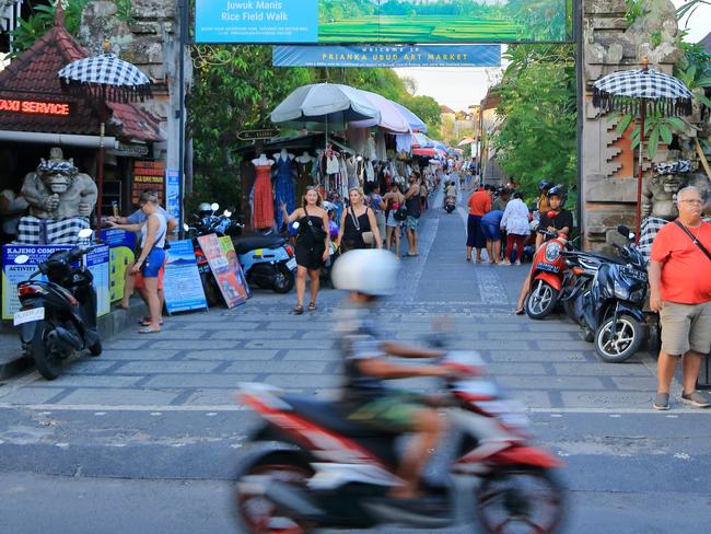 Ubud, Bali in Indonesia - January 30 2024: local people enjoy the city by motorbike