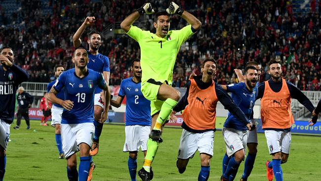 Italy’s players celebrate winning the World Cup qualifier against Albania.